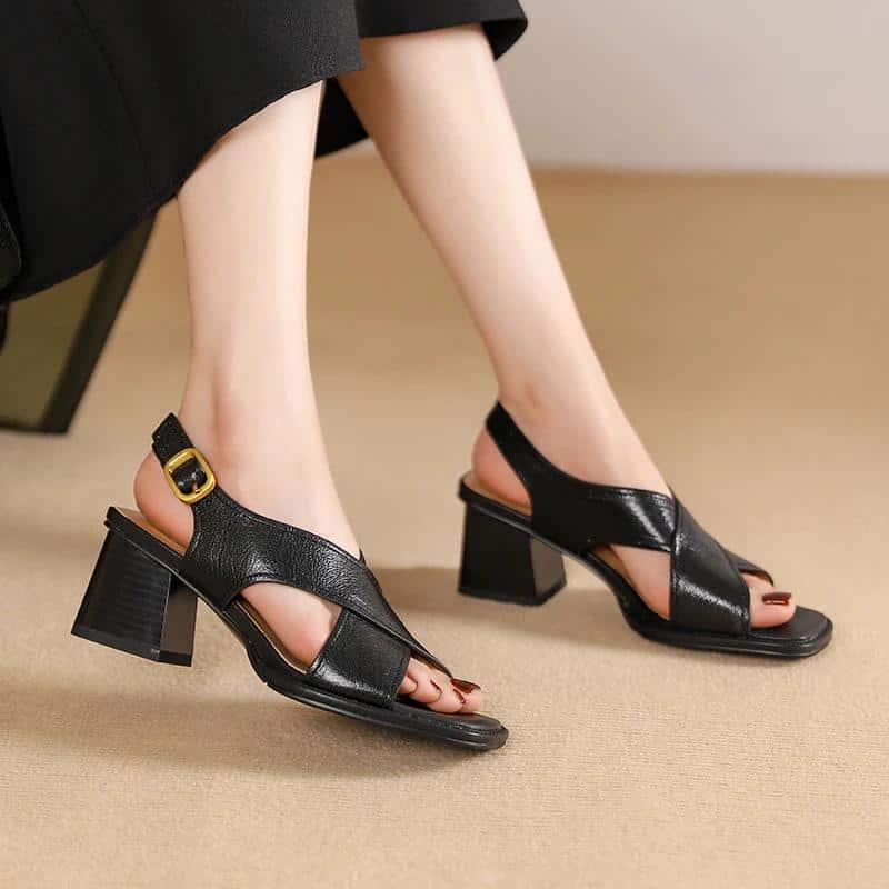 Stylish black leather sandals featuring a block heel and adjustable strap, perfect for women seeking comfortable and fashionable footwear in eye care or optical shop settings.