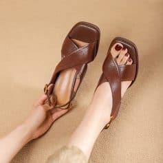 Comfortable brown leather women's sandals with a square toe and criss-cross straps, perfect for casual or dressy occasions. Adjustable buckle for a secure fit and chic design.