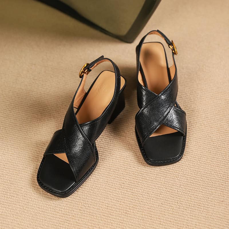 Elegant black leather open-toe sandals with chunky heels, perfect for women’s fashion and comfort. Ideal for work, casual outings, and special occasions.