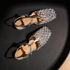 Elegant silver footwear featuring a unique lattice pattern, perfect for stylish occasions and complementing various outfits.