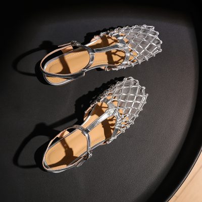 Elegant silver footwear featuring a unique lattice pattern, perfect for stylish occasions and complementing various outfits.