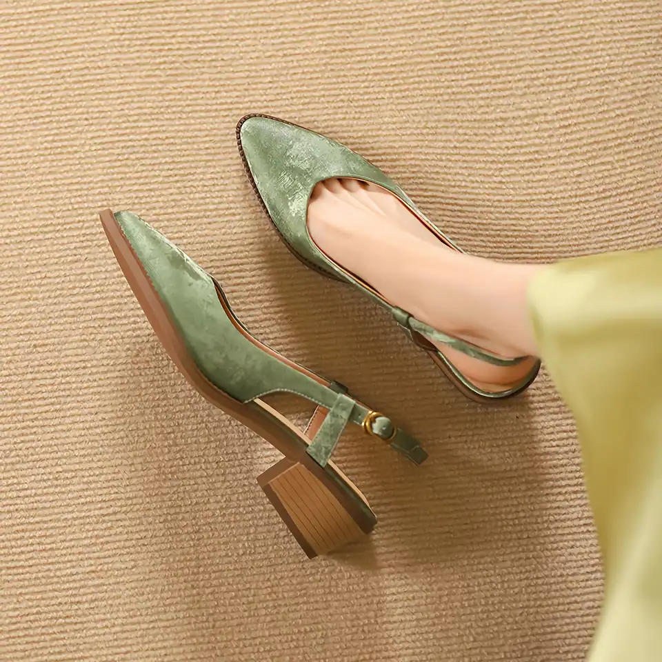 Elegant green velvet high heel shoes on beige carpet, stylish and comfortable footwear for women, perfect for fashion and special occasions.