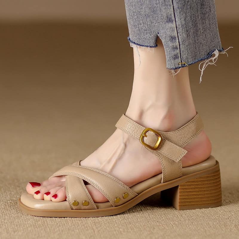 Elegant beige women’s sandal with ankle strap, gold buckle, and low block heel for comfort and style. Perfect for casual or dressy occasions, combining fashion and comfort seamlessly.