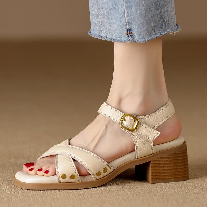 Comfortable beige leather sandal with ankle strap and gold buckle, perfect for summer and casual wear. Durable heel and trendy design enhance your style and comfort.