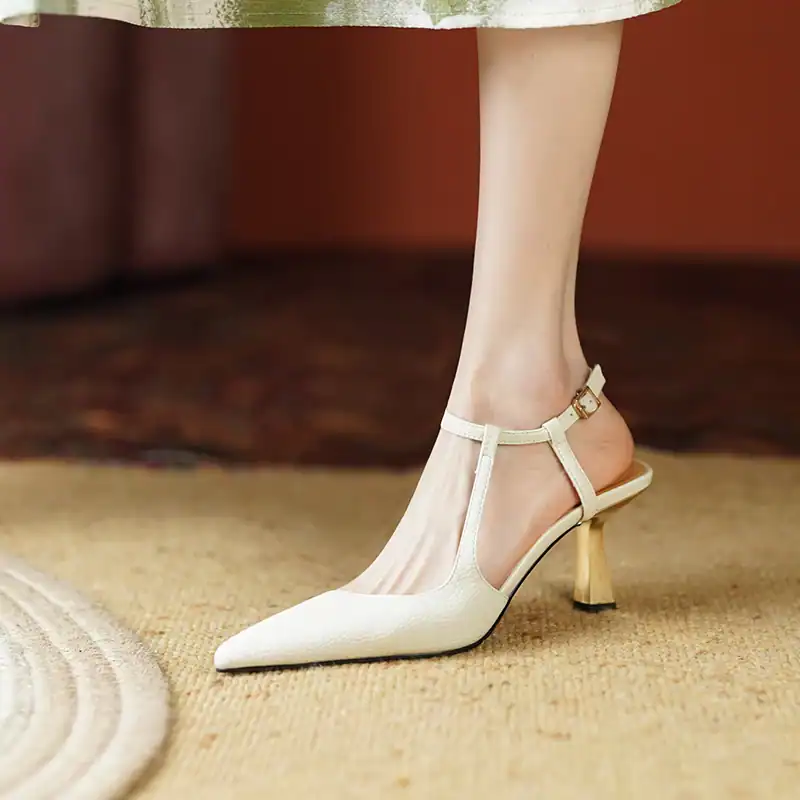 Elegant white women's high heel shoe with pointed toe and ankle strap, perfect for fashion-forward and professional looks.