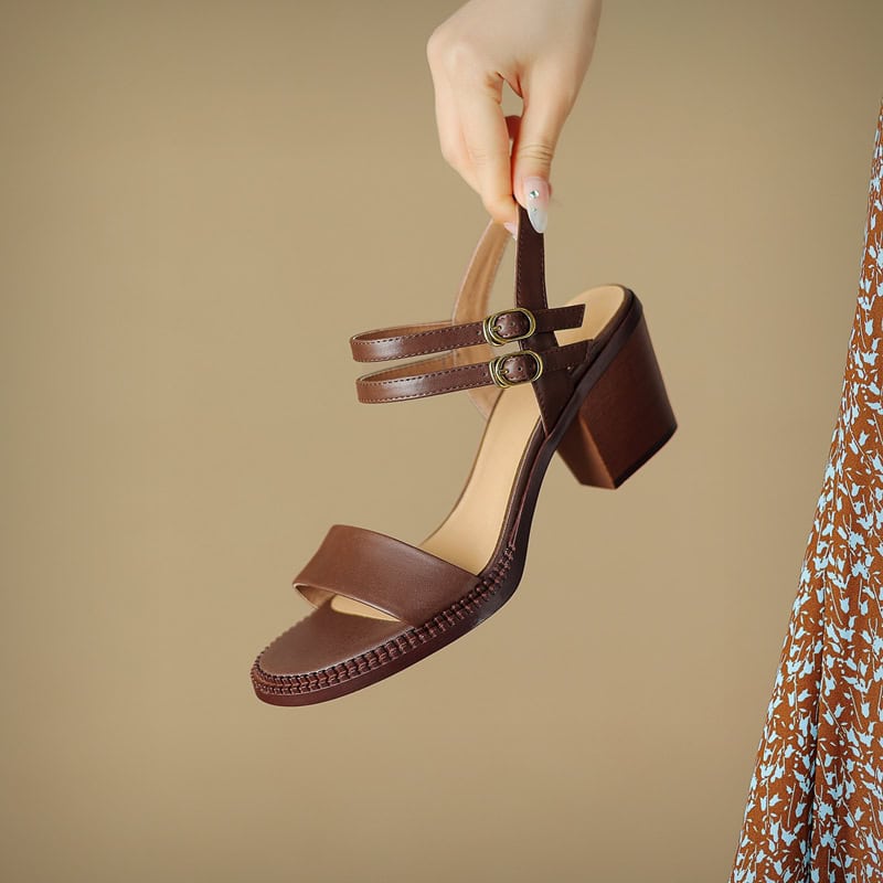 Elegant women's brown leather sandal with dual ankle straps and chunky heel, perfect for stylish everyday wear or special occasions.