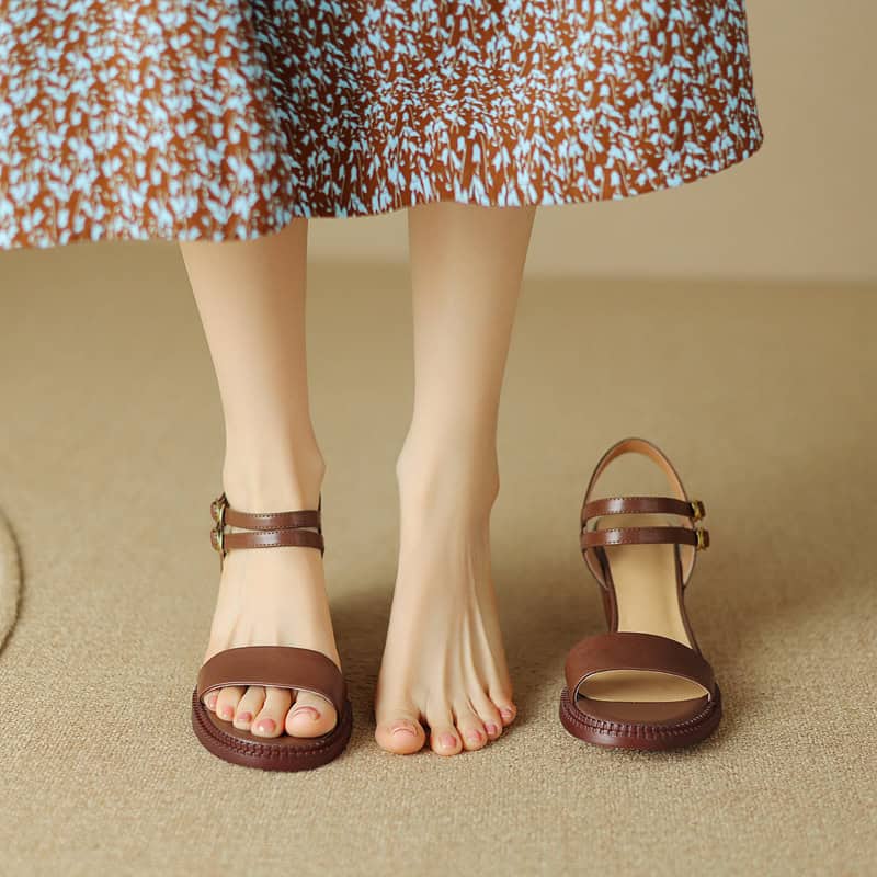 Elegant brown sandals displayed on a woman's feet with one shoe off, showcasing stylish footwear options available at Monalisa Store for women’s fashion and comfortable shoes.