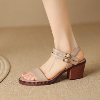 Elegant beige women's high-heeled sandals with ankle straps featuring gold buckles, perfect for fashion-forward occasions. Designed for comfort and style, these shoes are a versatile addition to any wardrobe.
