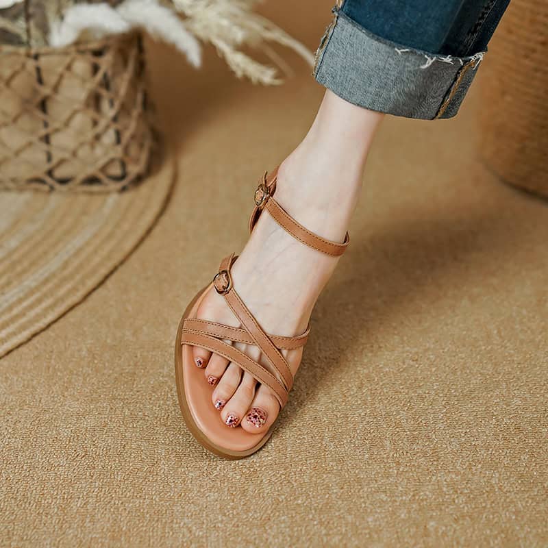 Elegant women's tan leather sandals with adjustable ankle straps, perfect for casual summer wear and everyday comfort.