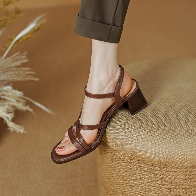 Close-up of a women's brown strappy heeled sandal with block heel, showcasing fashionable footwear perfect for summer or dressy occasions.