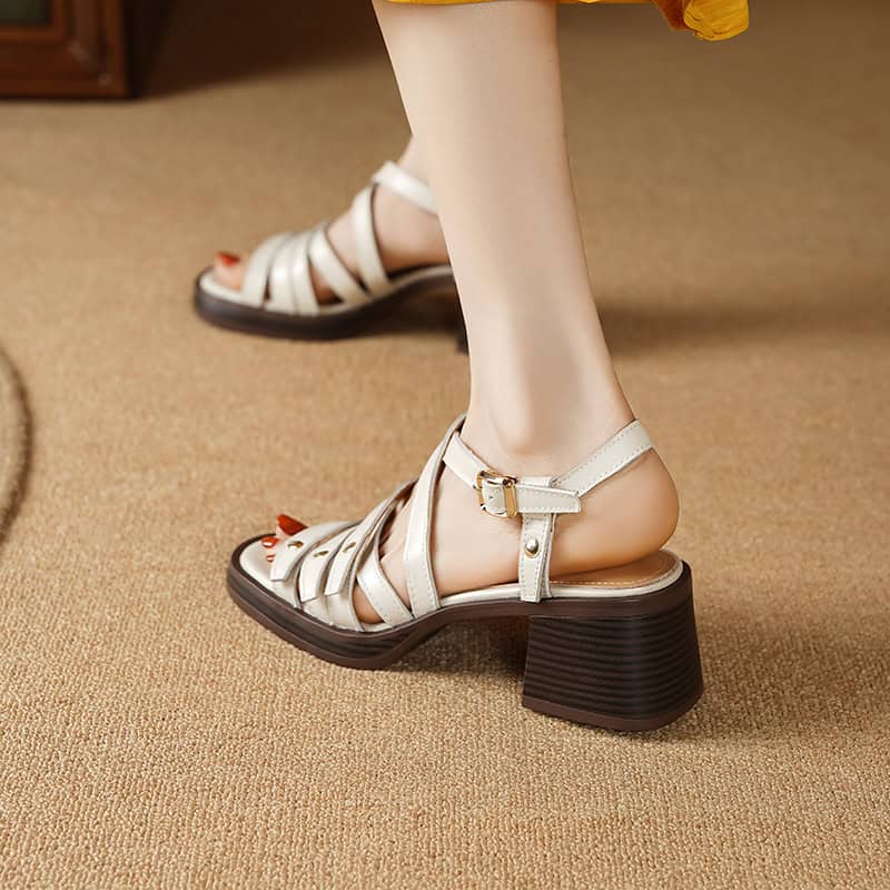 Elegant beige women’s sandals with block heels and adjustable ankle straps, perfect for casual or dressy occasions. Comfortable footwear for everyday wear and fashion.