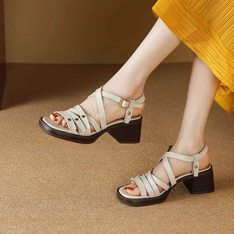 Elegant beige strap sandals with chunky block heels, perfect for stylish occasions or everyday wear. Comfortable and fashionable footwear for women.