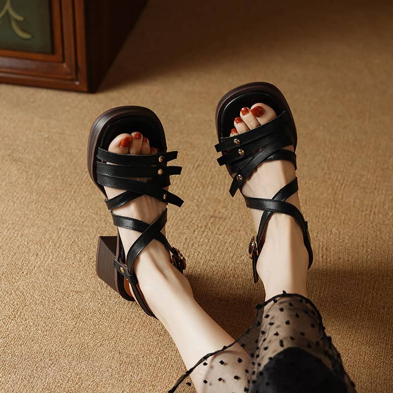 Elegant black strappy sandals with chunky heels, perfect for fashion-forward women seeking both comfort and style.