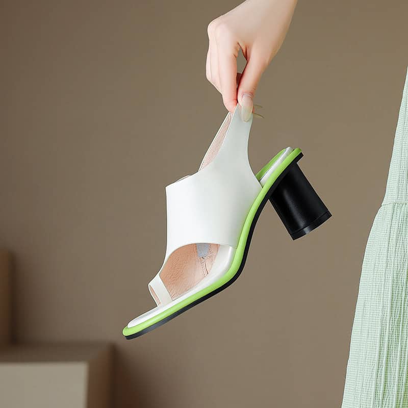 Elegant white high heel shoe with black heel and green sole, showcasing trendy footwear design. Perfect for fashion-forward women seeking stylish and comfortable shoes.