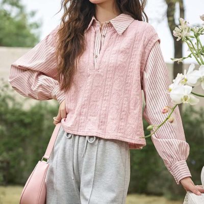 Elegant pink layered top with striped sleeves, paired with grey joggers and a pink handbag for a stylish, comfortable look. Perfect for outdoor activities and casual outings.