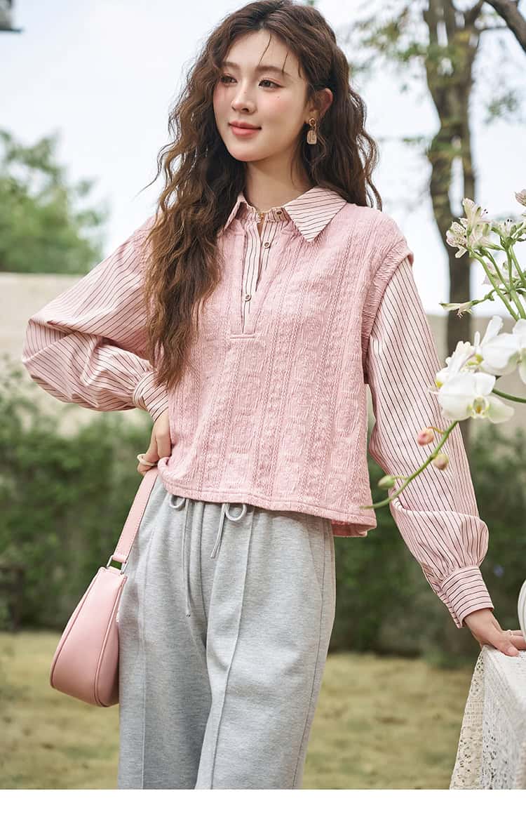 Elegant pink layered top with striped sleeves, paired with grey joggers and a pink handbag for a stylish, comfortable look. Perfect for outdoor activities and casual outings.