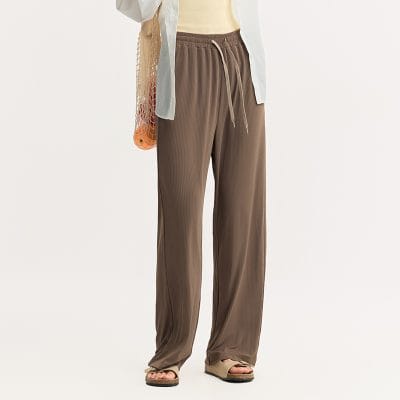 Comfortable beige wide-leg trousers with a high waist, elastic drawstring, and soft fabric. Perfect for casual or professional wear, versatile and stylish.