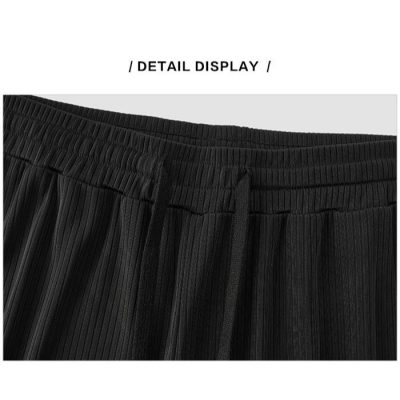 High-quality black pleated shorts for men, featuring an adjustable waistband and comfortable fit, perfect for casual or athletic wear.
