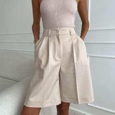 A stylish pair of high-waisted beige wide-leg shorts perfect for casual or semi-formal outfits, offering comfort and fashion for women.