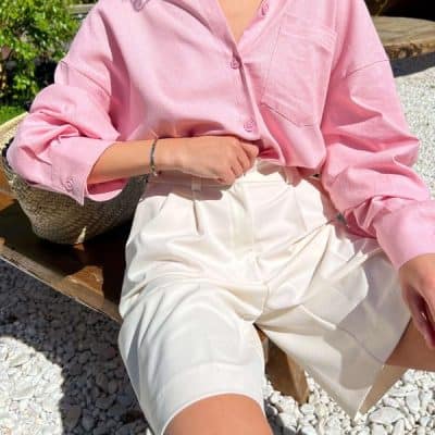 Stylish pink blouse paired with white shorts, showcasing trendy eyewear options for modern fashion enthusiasts at Monalisa Store.