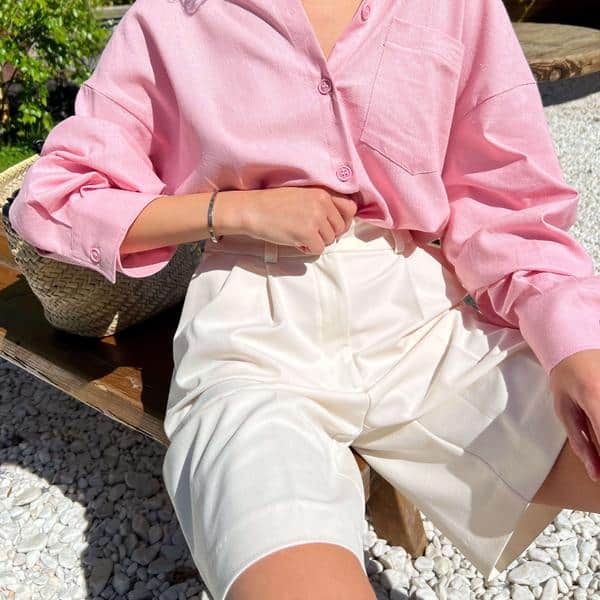 Stylish pink blouse paired with white shorts, showcasing trendy eyewear options for modern fashion enthusiasts at Monalisa Store.