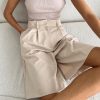 Stylish beige tailored shorts for women, ideal for casual or formal wear, combining comfort and modern fashion.