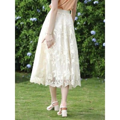 A stylish cream lace midi skirt perfect for casual or semi-formal occasions. Features intricate floral embroidery, scalloped hem, and comfortable fit for a fashionable look.