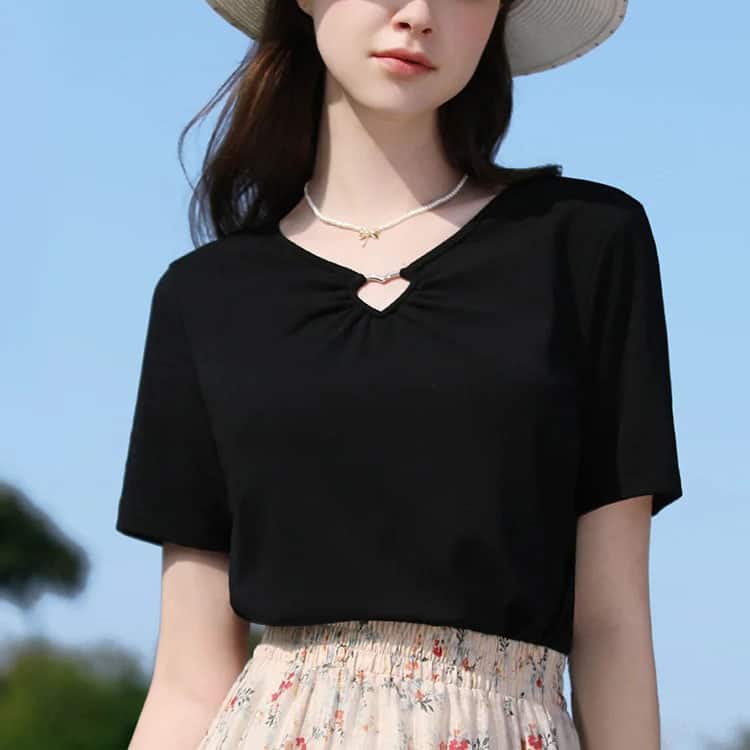 Elegant black casual top for women with a stylish keyhole neckline, perfect for everyday wear and outdoor outings. Comfortable fit, versatile fashion piece ideal for summer.