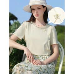 Stylish women's light beige summer blouse with delicate bow detail and ruffle accents, perfect for warm weather and outdoor activities.