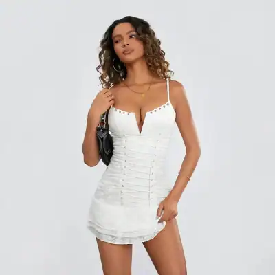 Elegant white mini dress with lace-up detail and unique neckline, perfect for trendy fashion and stylish occasions.