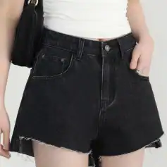 Modern black denim shorts featuring raw hem, high waist, and classic five-pocket design, ideal for casual and trendy summer looks.