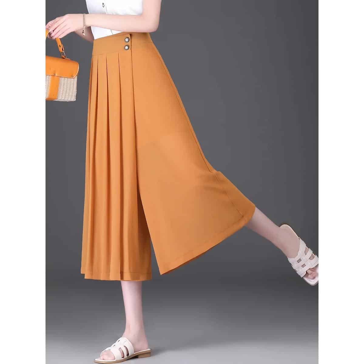Bright orange high-waisted wide-leg trousers featuring pleats, side buttons, and a comfortable fit, perfect for fashion-forward women.