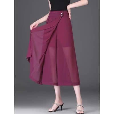 A stylish maroon wide-leg skirt featuring pleats and side buttons, perfect for office and casual wear. Made from lightweight, breathable fabric for all-day comfort.