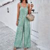 Light green wide-leg jumpsuit with white floral pattern, sleeveless with shoulder straps, perfect for summer outings or vacation style.