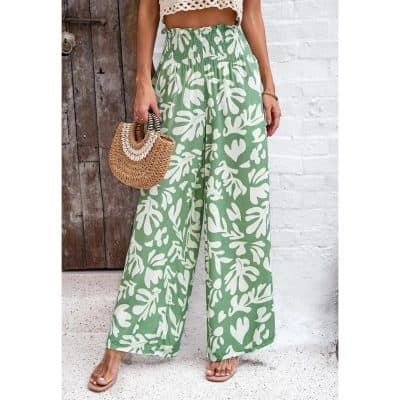 Stylish green and white tropical pattern wide-leg pants perfect for summer, vacation, or casual wear. Comfortable high-waisted design with flowy silhouette for a fashionable beach or resort look.