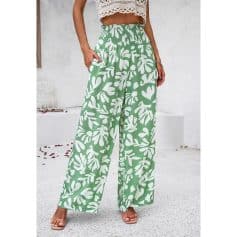 Stylish green and white wide-leg pants with a bold floral pattern, perfect for casual or beachwear, offering comfort and trendy summer style.