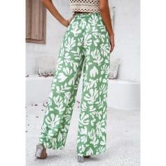 Elegant wide-leg green pants with bold white floral pattern, perfect for stylish summer wear and casual outings.