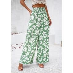 High-quality women's wide-leg pants featuring a vibrant green color with a white botanical leaf print, perfect for casual and summer wear.