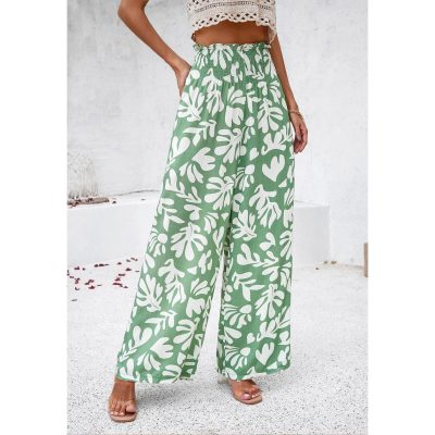 High-quality women's wide-leg pants featuring a vibrant green color with a white botanical leaf print, perfect for casual and summer wear.