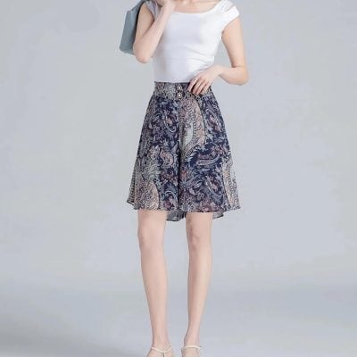 Photo of a fashionable woman wearing a stylish, patterned knee-length skirt, perfect for summer wear and casual stylish looks.