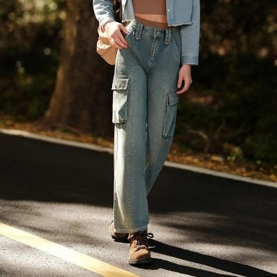 A woman wearing relaxed cargo jeans walking outdoors, showing off a casual and trendy style with durable denim, multiple pockets, and a comfortable fit, perfect for daily wear.