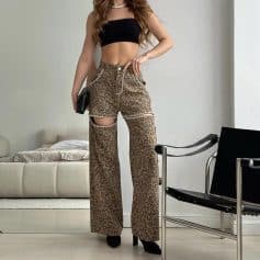 Stylish women’s leopard print wide-leg pants with cut-out design, paired with a black crop top, perfect for casual or trendy fashion statements.