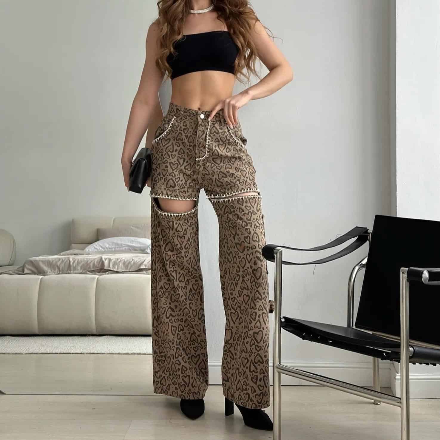 Stylish women’s leopard print wide-leg pants with cut-out design, paired with a black crop top, perfect for casual or trendy fashion statements.