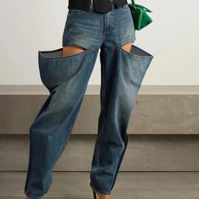 Stylish high-waisted denim jeans featuring cut-out design for a trendy, edgy look. Perfect for fashion-forward individuals seeking unique, statement-making styles.