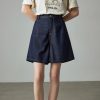Stylish high-waisted denim shorts with a wide-leg fit, perfect for casual, summer, or beachwear. Comfortable and trendy, ideal for women seeking versatile denim fashion.
