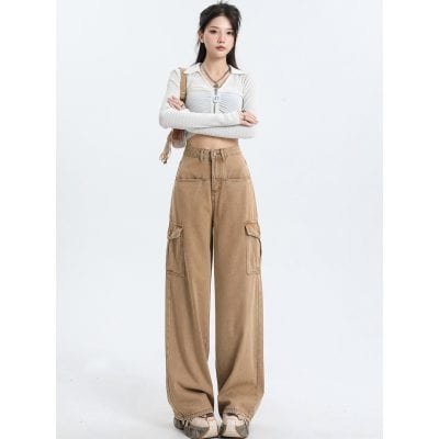 Image of a stylish woman wearing beige wide-leg cargo pants paired with a white cropped top and accessories, showcasing fashionable and comfortable clothing options available at Monalisa Medical Store.