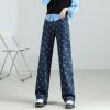 Comfortable wide-leg denim pants with moon print, perfect for everyday fashion and stylish eyewear storage.