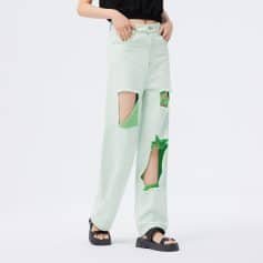 Bright green ripped high-waisted distressed jeans for women, fashionable denim with large holes, trendy streetwear style. Perfect for casual, fashion-forward looks.