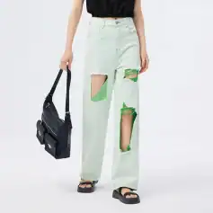 Stylish wide-leg jeans featuring unique green patches and distressed design, perfect for casual and urban fashion looks.