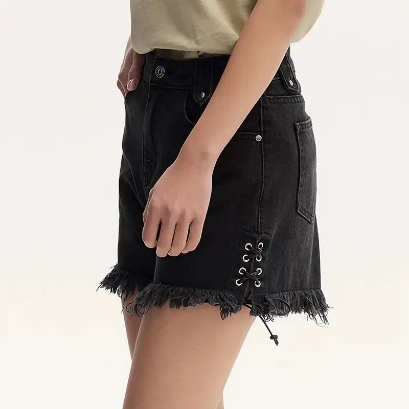 Stylish black distressed denim shorts with lace-up side detail and frayed hem for a trendy, casual look. Perfect for summer and streetwear fashion.
